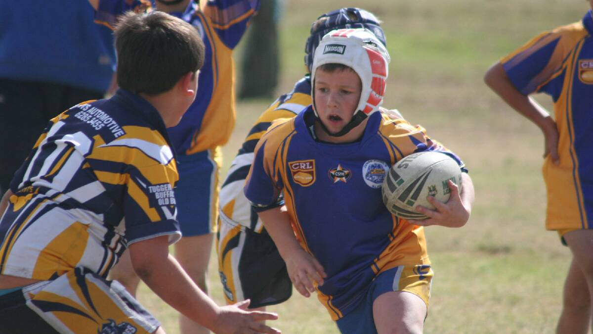 Blayne Linsell charges forward in Under 8s.
