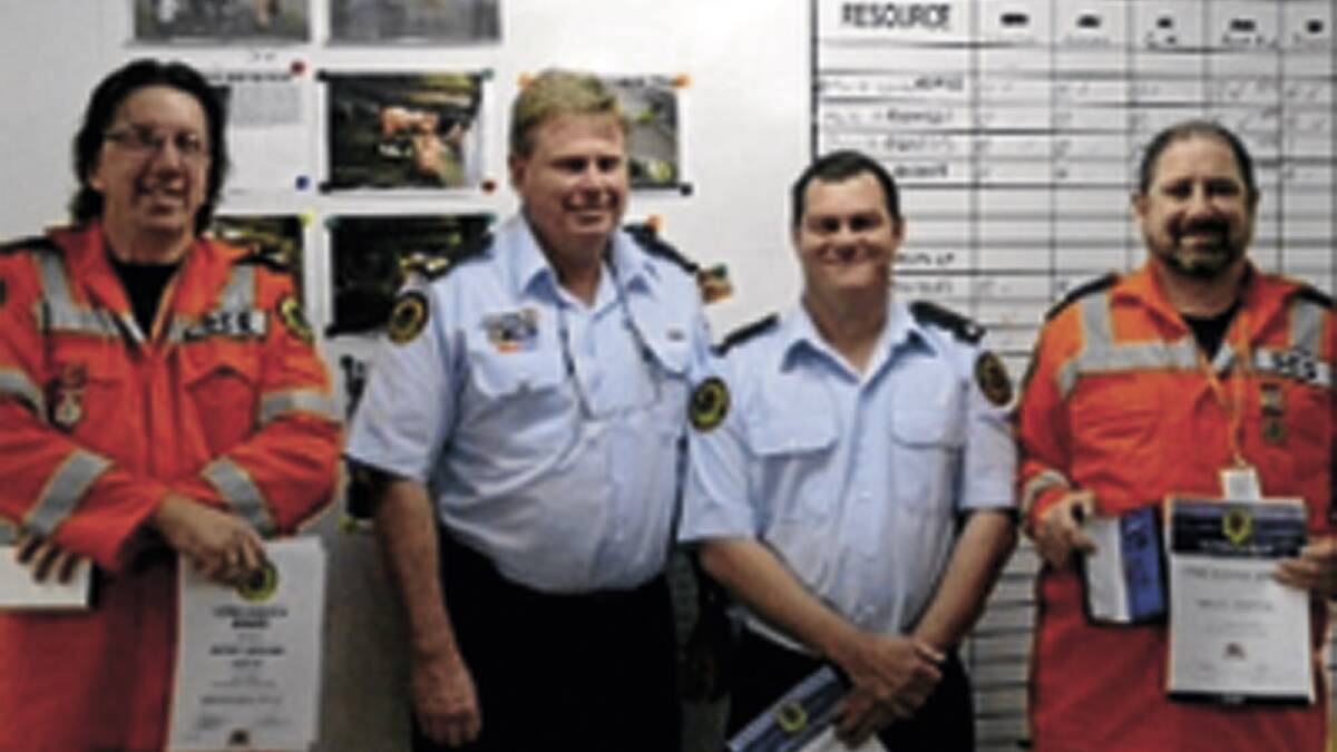 DEDICATED BUNCH: Junee SES team leader Michael Anschaw, NSW SES assistant commissioner Mark Morrow, Junee SES local controller Michael Webb and Junee SES team leader Brett Porter gather following a presentation of long service medals.