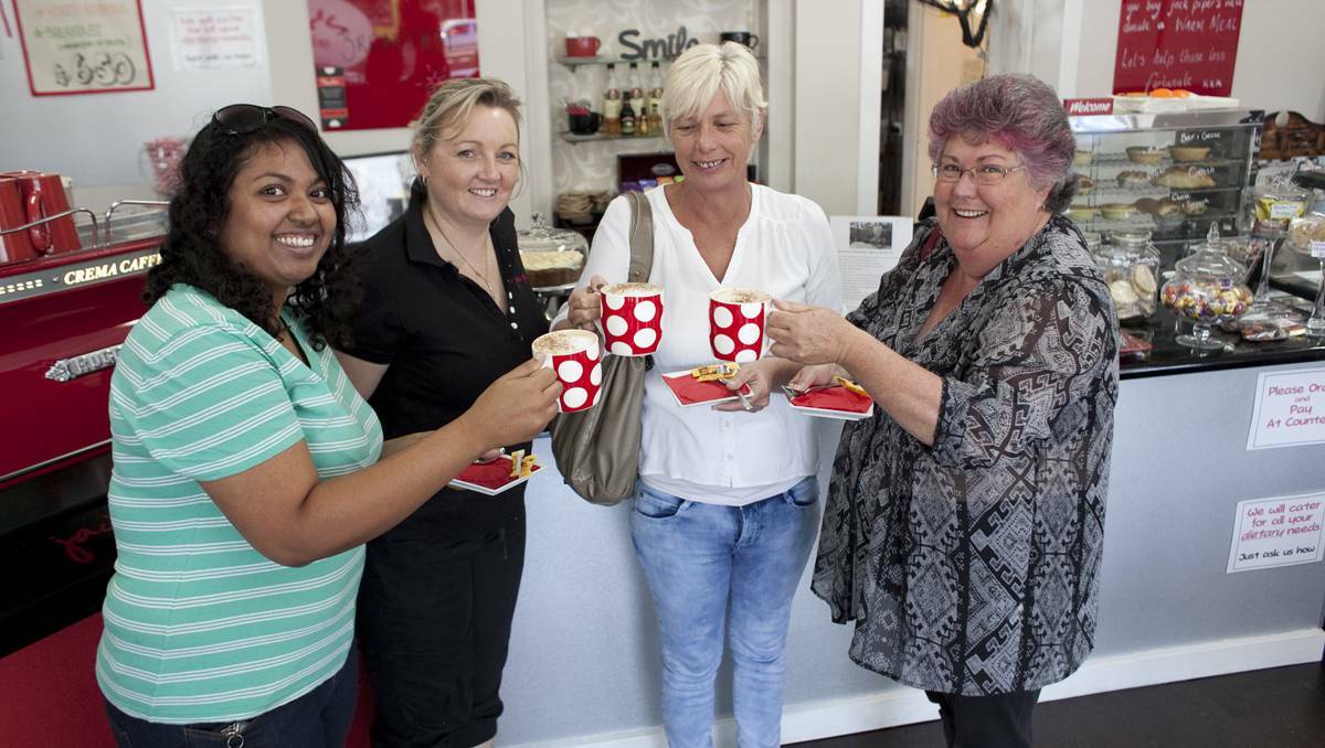  Homelessness services workers Thanuja Hiripitiyage, Trish Spark and Helen Liebelt will distribute vouchers for free meals and coffee donated by customers at Jack Piper's, co-owned by Rebecca Vardon, pictured second from left.