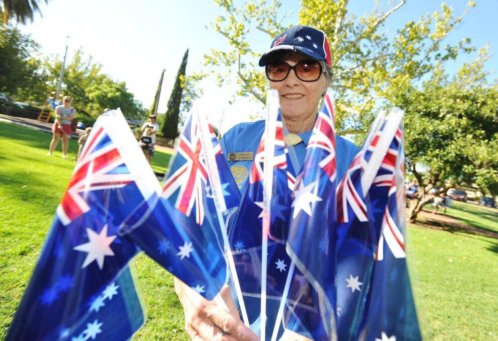 President of the Narrandera Soroptimist group Roxy Heckendorf handing out flags at the Australia Day Celebrations in Narrandera. Picture: Alastair Brook