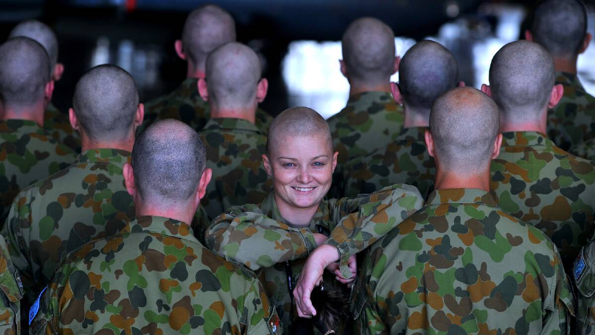 In a sea of bald heads Wagga ACW Shaylene Macartney was the only women to have her head shaved as the RAAF Base’s School of Technical Training course students hold a fund-raiser where they had their heads shaved in support of their friend, Aircraftsman Scott Grant, who has recently been diagnosed with stage four lymphoma. Picture: The Daily Advertiser