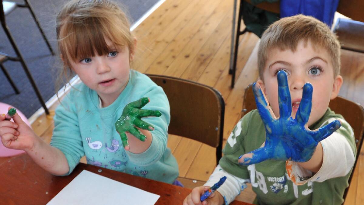 Cameron Robinson (right), 4, and Savanna Walker, 3, prepare to put paint to paper as part of a world record attempt to celebrate the South West Family Day Care's 25th anniversary. Picture: The Daily Advertiser