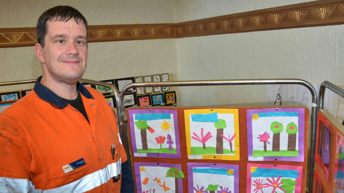 Councillor Matt Austin takes a peak at work by Junee North Public students. Picture: Declan Rurenga