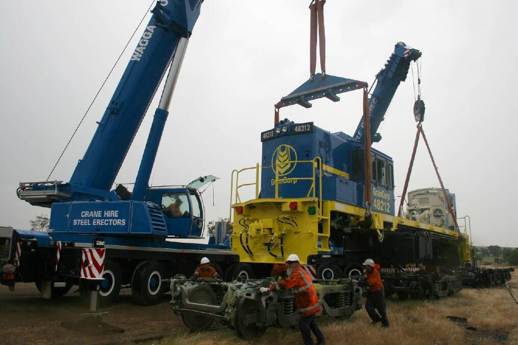 Once the locomotive has been lifted high enough, the bogies are rolled out from under it. Picture: Declan Rurenga
