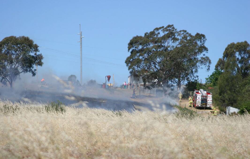 A grass fire broke out in a paddock near Waterworks Road in Junee on Monday. Picture: Declan Rurenga