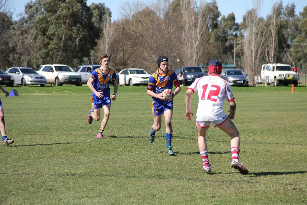 Cameron Hands (centre) and Lochie Landrigan (left) push forward against the Dragons. Picture: Liz Cowled