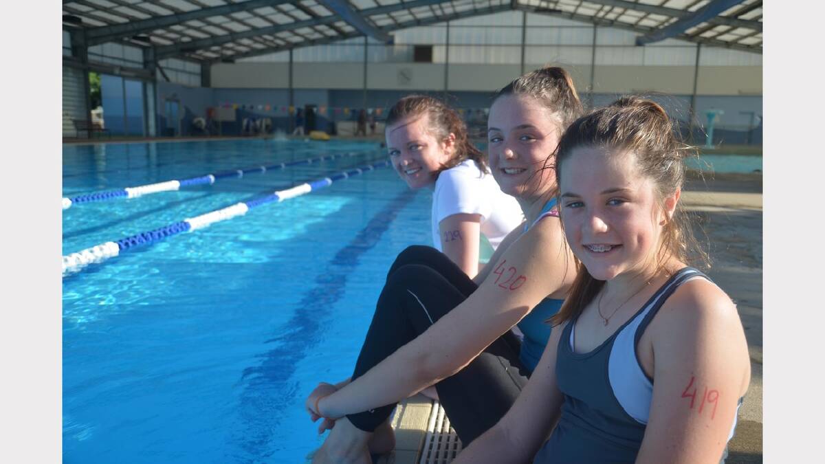  Ellie Heffernan, Caitlin Heffernan, 15 and Frances Heffernan, 11 relax by the pool. Picture: Declan Rurenga