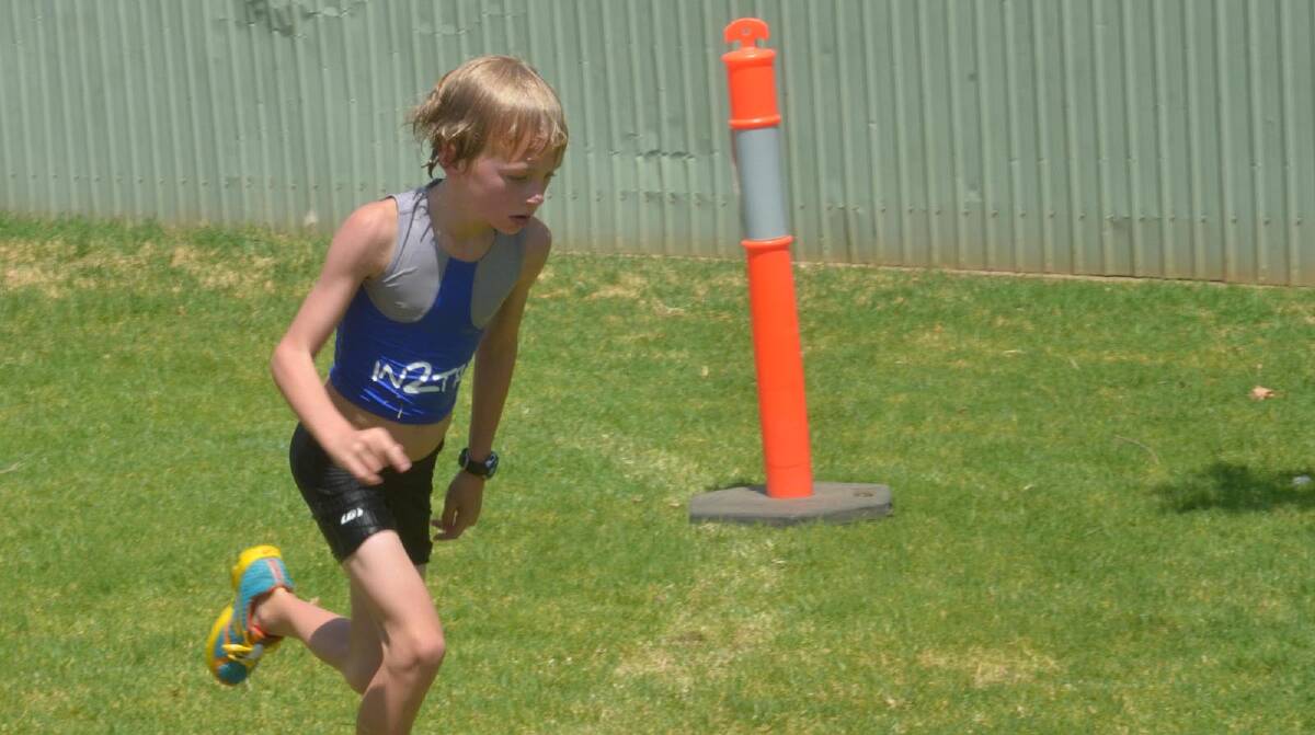 Hamish Hart, 8 in the run leg of the mini triathlon. Picture: Declan Rurenga
