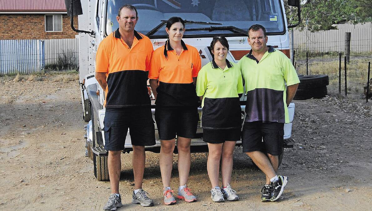 SAME BUSINESS, NEW OWNERS: (From left) Craig “Max” Walker and Kylie Sheather this week took over Junee Freight Lines from Larnie and Terry Bourke. Picture: Annette Wright