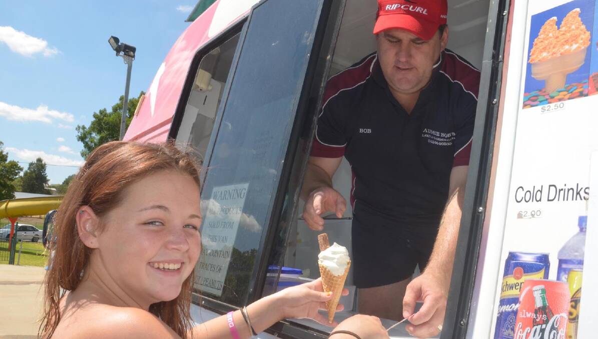 Hayley Hackett, 12 gets an icecream off Bob Wood. Picture: Declan Rurenga