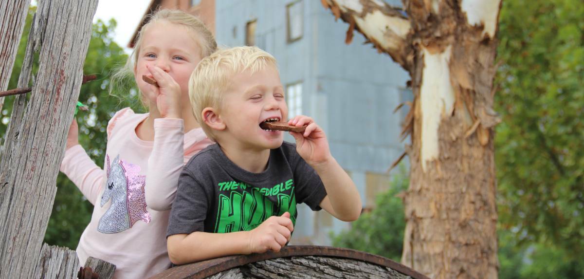 SATISFIED CUSTOMERS: Isabella Sweatman, 5, getting stuck into an Easter chocolate treat with her brother Harrison Sweatman, 3, at the Junee Licorice and Chocolate Factory. 