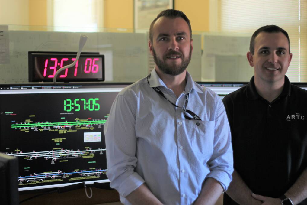 Project manager Mitchell Sweeney and network controller Ben Lawson inside Junee's ARTC operational centre.