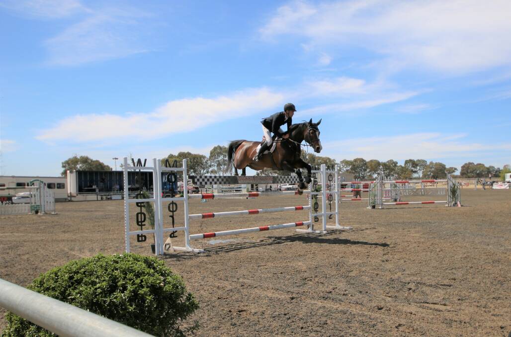 PERFECT RUN: Tom McDermott completes a faultless course by clearing the 1.5 metre fence with horse Elegance De La Charmille at Wagga's Charles Sturt University Equine Centre. Picture: Emma Horn