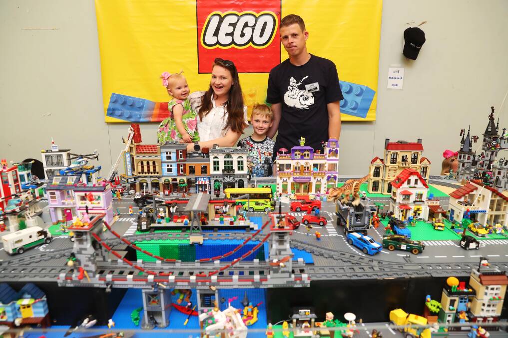 TOY TOWN: Amy 1, Blaer, Kevin 8, and Shaun Wishart with their Lego town and trains. Picture: Emma Hillier