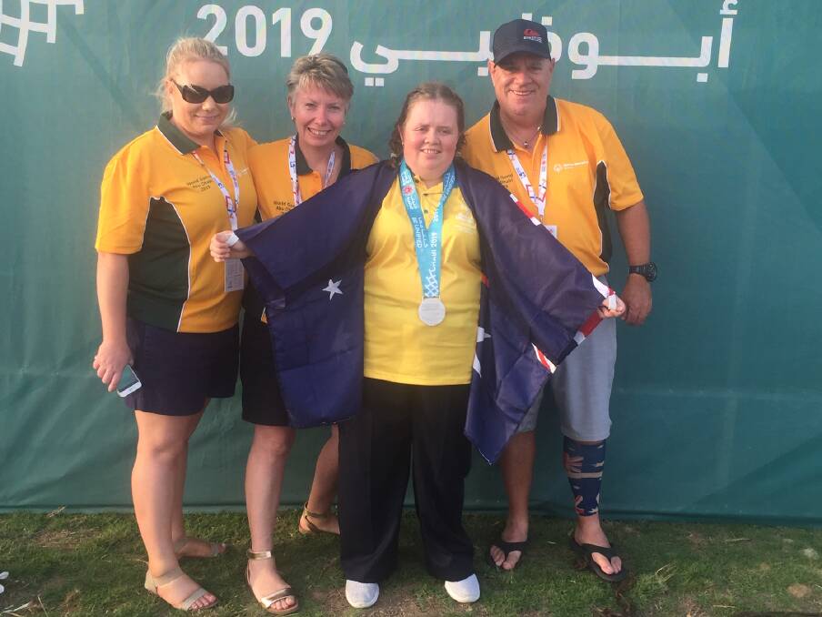 SWAG: Madison Sims shows off her silver medal in Abu Dhabi with her sister, Danielle, and parents, Janelle and Brett, behind her. Picture: supplied