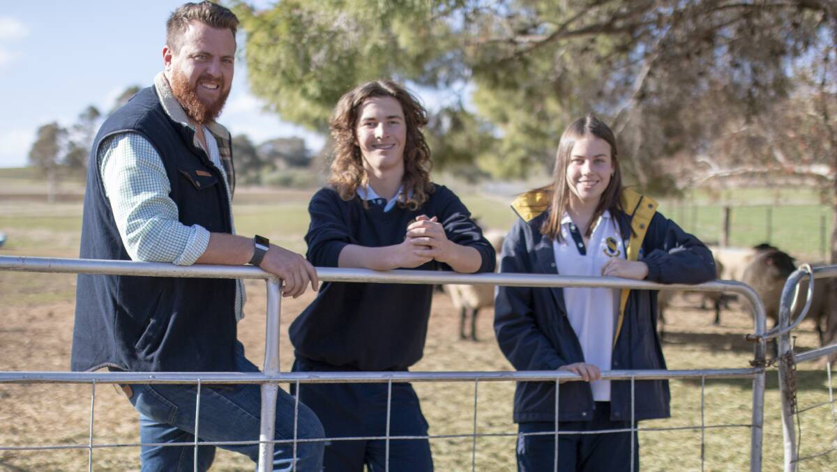 Junee High School Ag Vision coordinator Paul Anderson with farm managers Declan Honner and Lauren Anderson. Picture: Emma Horn