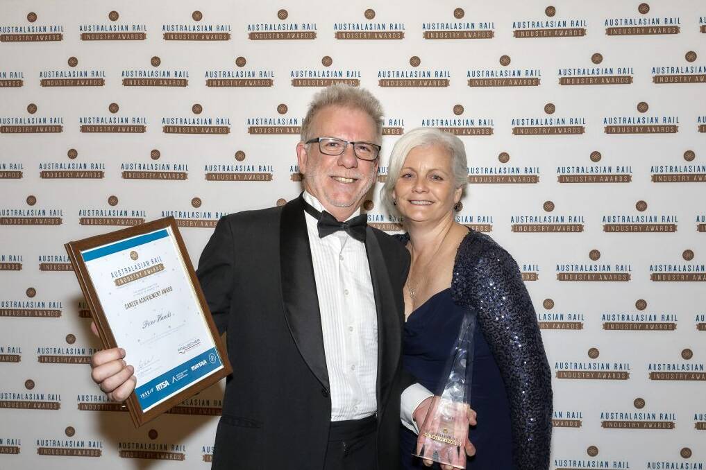 RAILWAY FAME: Peter Hands and wife Julie with the Master Career Achievement Award at the Australasian Rail Industry Awards in Melbourne on July 5. Picture: supplied