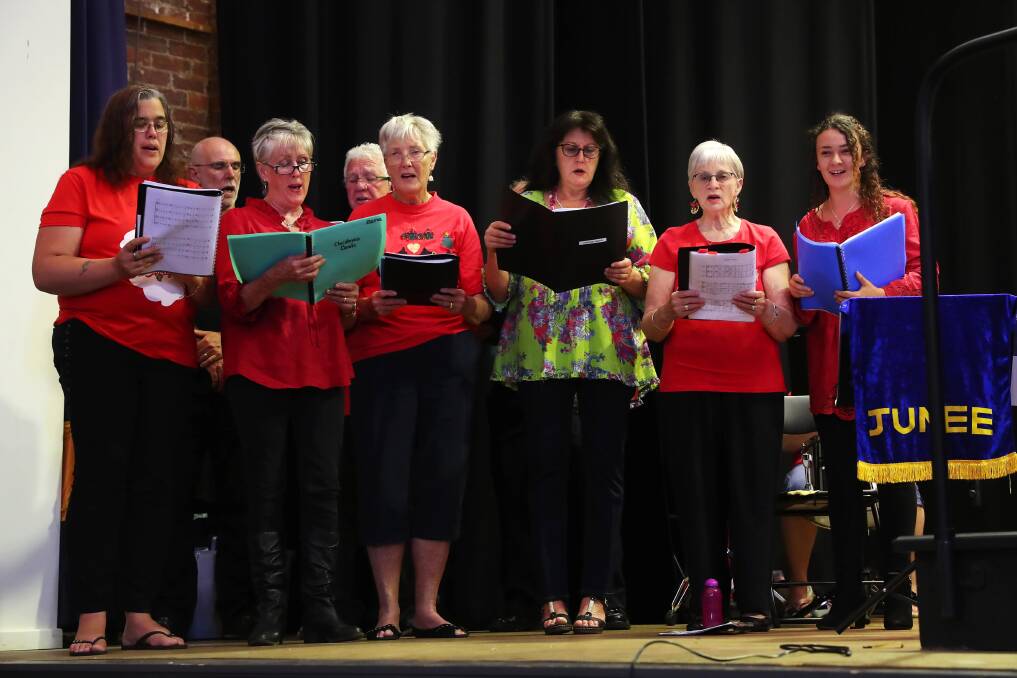 Junee Community Choir leading the carols at the Athenium Theatre on Sunday. Picture: Emma Hillier.