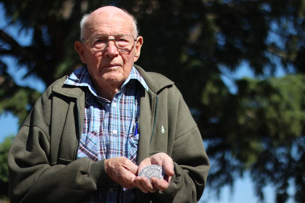 SERVICE HONOURS: Dal Eisenhauer holds his Royal Agricultural Society medallion, given in recognition his volunteering since 1947. Picture: Emma Horn
