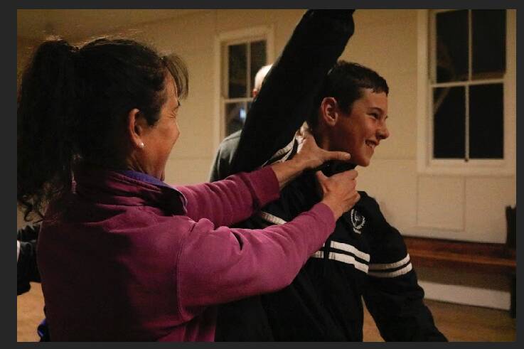 TALKING DEFENCE: Elissa Drew and her 12-year-old son Samuel performing the front choke release at the defence workshop in Eurongilly Hall. Picture: Ben Leak