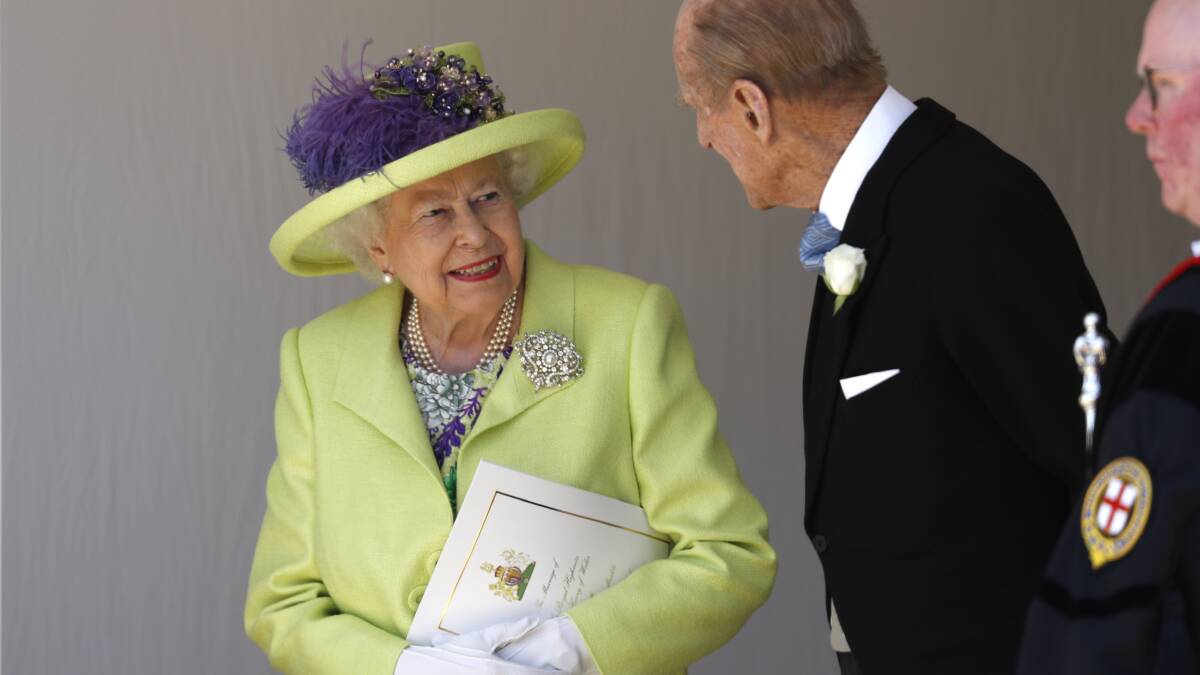 Britain's Queen Elizabeth talks with Prince Philip after the wedding ceremony of Prince Harry and Meghan Markle at St. George's Chapel in Windsor Castle in Windsor, near London, England, Saturday, May 19, 2018. (AP Photo/Alastair Grant, pool)