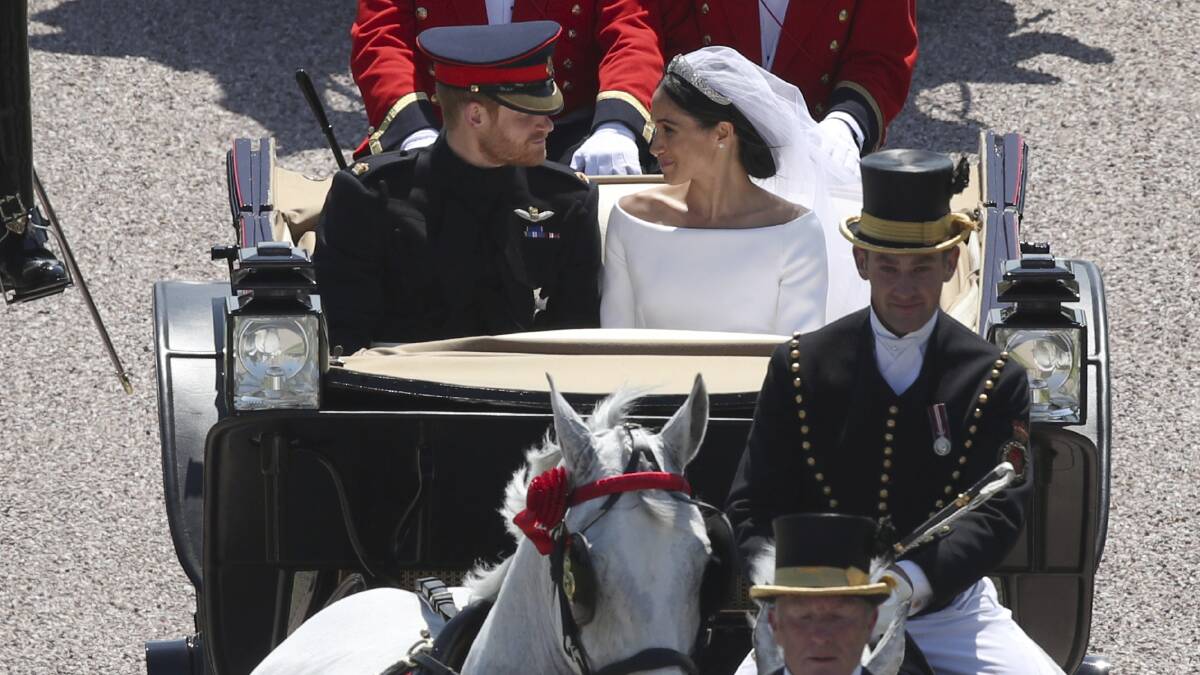 Britain's Prince Harry and Meghan Markle leave in a carriage after their wedding ceremony at St. George's Chapel in Windsor Castle in Windsor, near London, England, Saturday, May 19, 2018. (Yui Mok/pool photo via AP)
