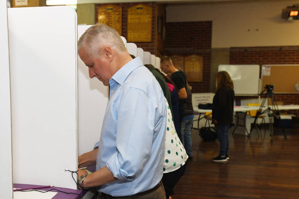 IN THE BOOTH: Riverina MP incumbent Michael McCormack casting his vote at South Wagga Public School on Saturday morning.