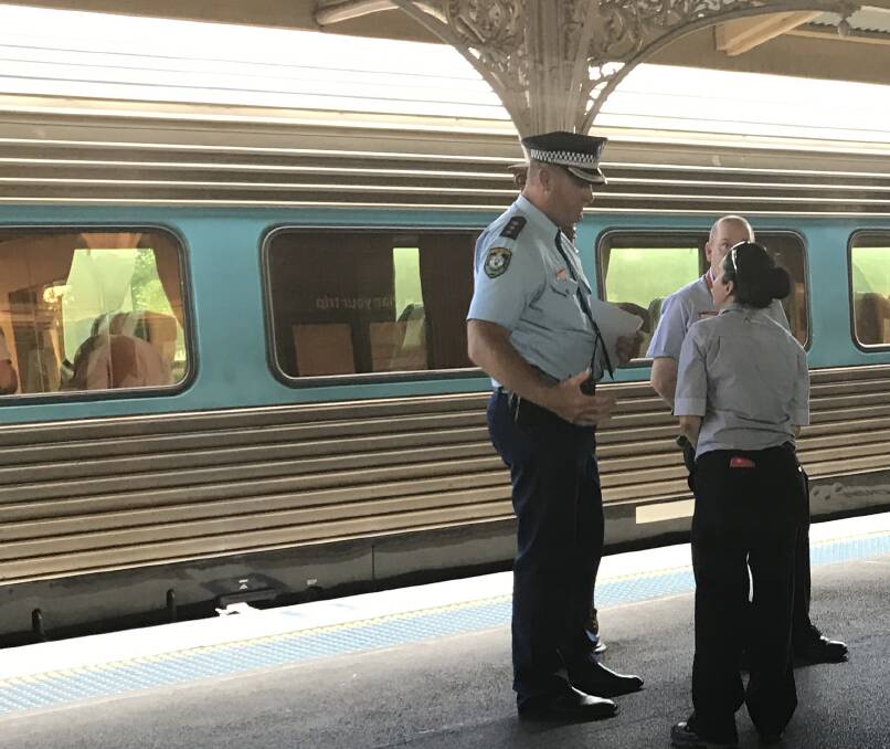 Police discuss the situation on the platform at Cootamundra train station. Picture: Supplied