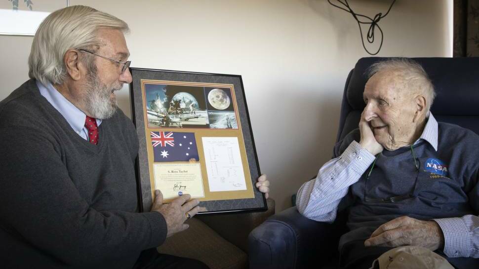  Former NASA scientist, Dr Everett Gibson (left) presents Professor Ross Taylor with official recognition for his 50 years of research. The plaque contains his results from fifty years ago and an Australian flag that has been to the moon. Picture: Sitthixay Ditthavong 