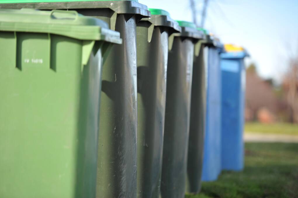 OVERFLOWING: Green waste bins in the town's north are overflowing in the back lanes after residents' rubbish collections were once again missed. Picture: Michael Frogley 