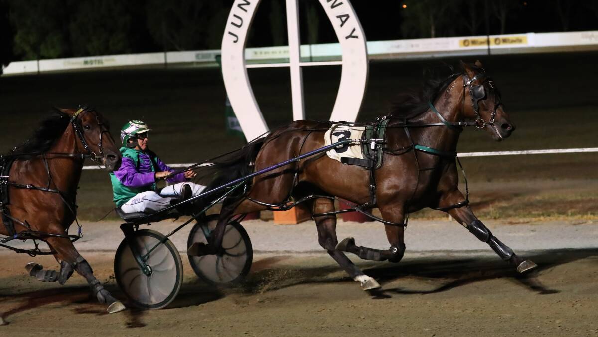 HOLDING STRONG: Major Roll kept his rivals at bay to win the Junee Pacers Cup for Stephen Maguire on Sunday night. Picture: Emma Hillier