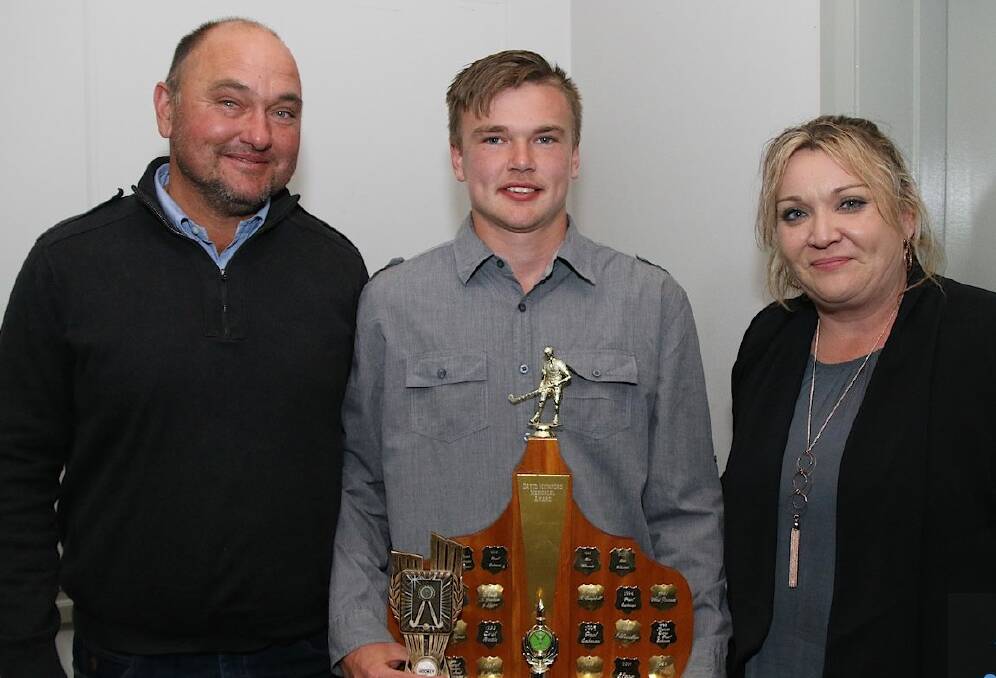 PROUD MOMENT: Phil and Tammy Makeham celebrate with son Riley after he named best and fairest in Wagga Hockey on Saturday. 