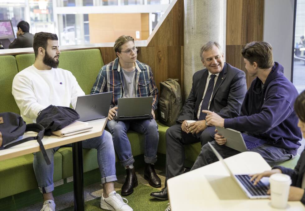 Pushing ahead: Professor Alex Zelinsky with students. He said there are clear links between university attendance and student success. Picture: Peter Stoop