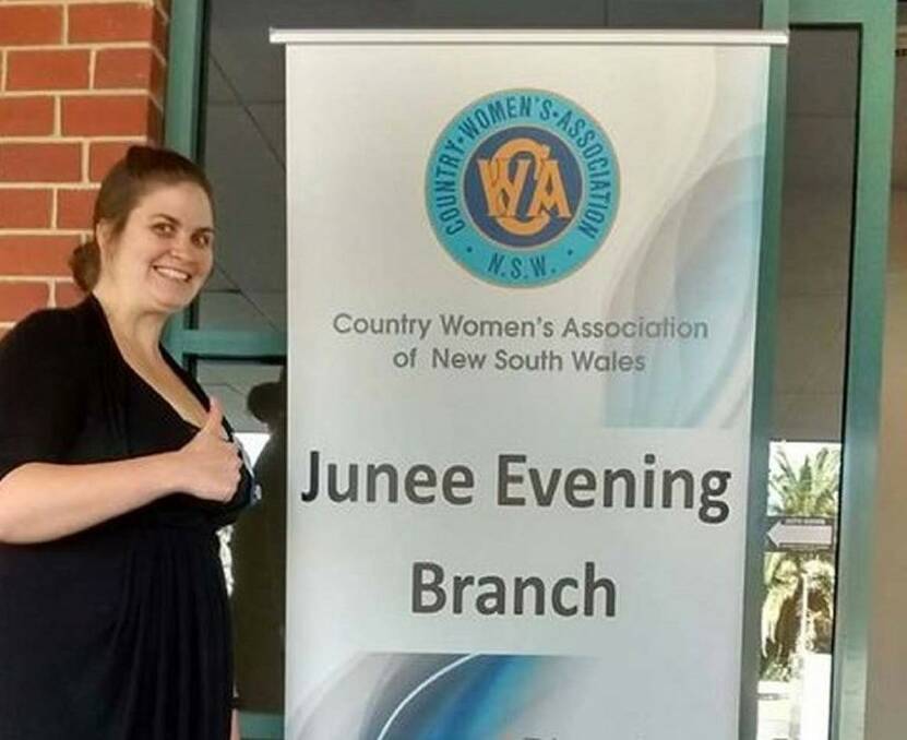 HAPPY: President Hannah Kruger proudly displays the Junee CWA Evening Branch's new banner. The branch and its members have been kept very busy. Picture: Contributed
