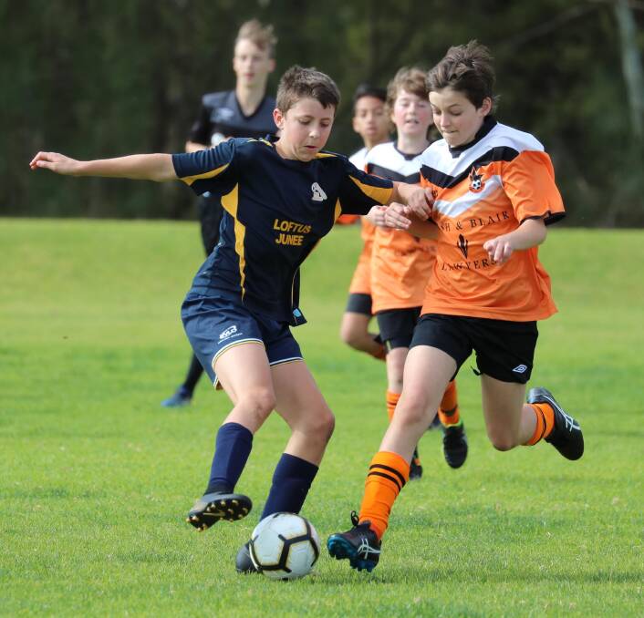 SPORTS: Tom Collins-McAlister and Samuel Baggett in the Junee Jaguars v Wagga United under 13 game at Burns Park. Picture: Les Smith