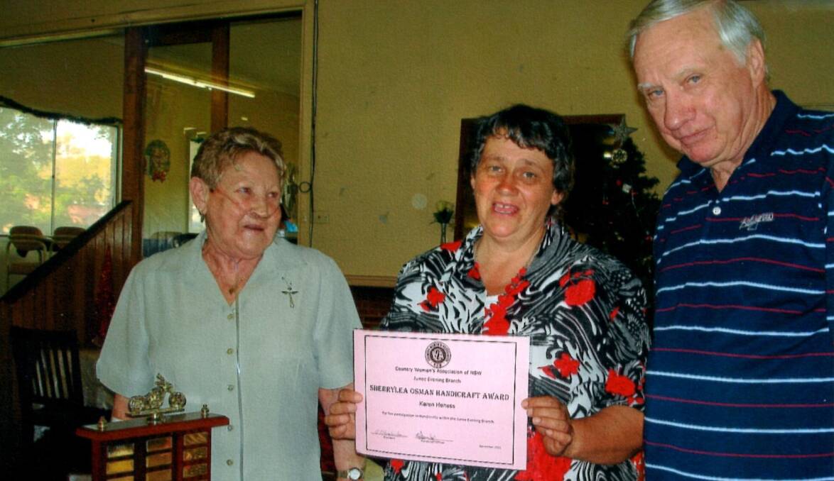 WELL DONE: Karen Heness receives her award from Irene and Barry Fuller. Picture: Contributed