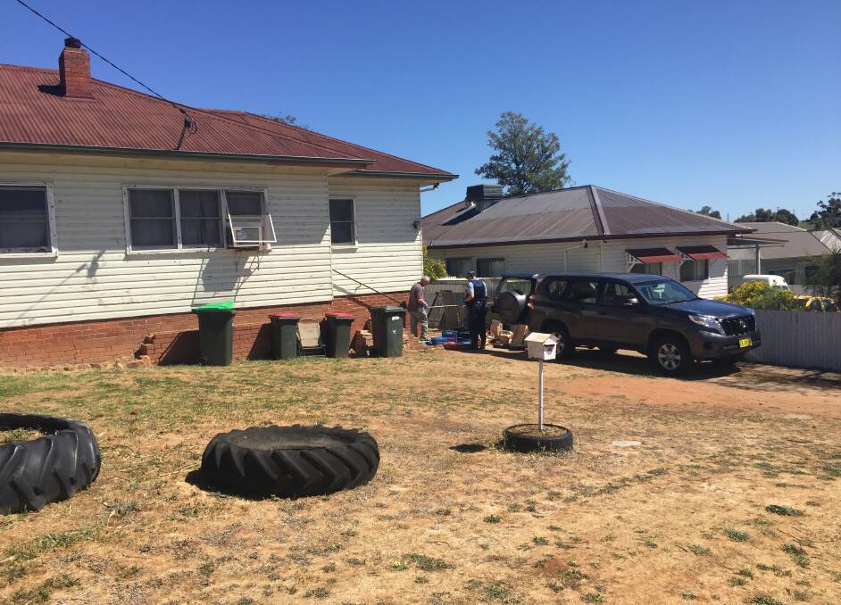 SEARCH WARRANT: Police collecting items seized from this house in Robert Street, Junee.