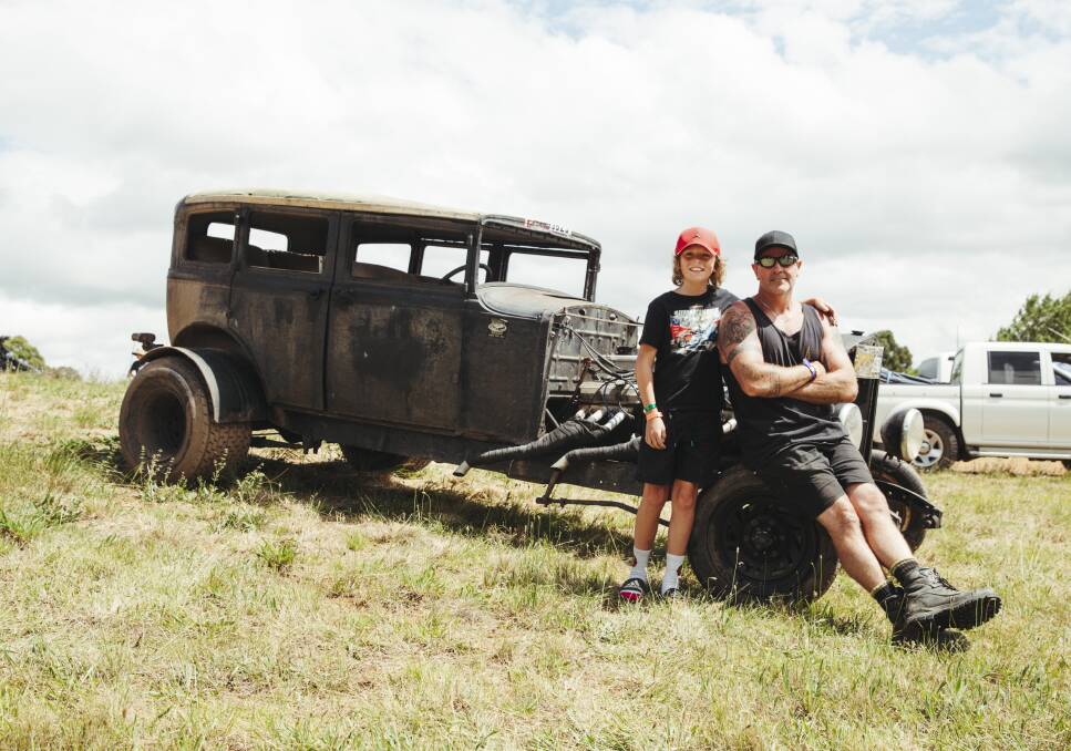 Sometimes the oddball cars get the most attention: Adam Spencer with his son, Maximus, and the 1929 V12 Graham-Paige rat rod. Picture: Dion Georgopoulos