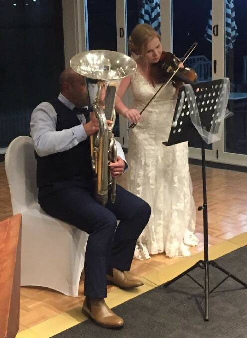 MUSICAL SURPRISE: Michael and Sarah Greenhill surprises their guests with a musical number after their wedding ceremony. They played the tuba and the violin side-by-side in a special touch to the big day. Picture: Supplied. 