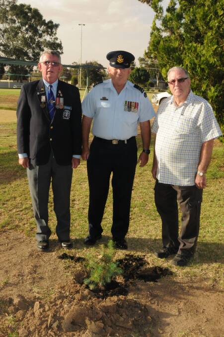 President of the Junee RSL Sub-Branch, John Robertson, squadron leader and vice-president of the Junee RSL sub-branch, Peter Hogarth, and president of the Junee Ex-Services club, Bill Hulm are ready to plant the tree. Picture: Graham Besley 