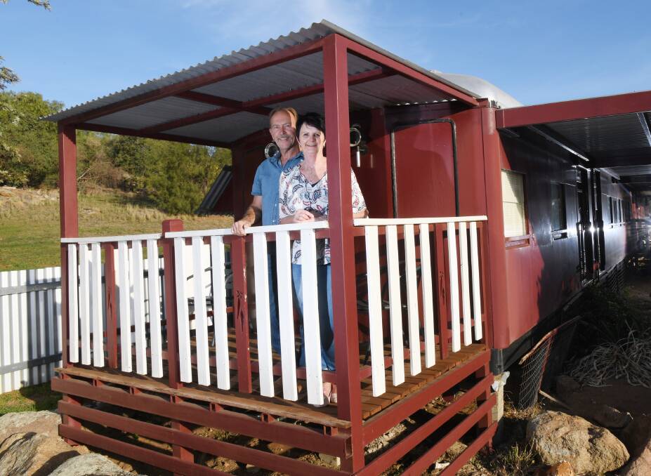 ALL ABOARD: Allan and Diane Tucker of Junee on a rail carriage, which they decided to convert into a bed and breakfast accommodation for tourists travelling from many countries in the world.