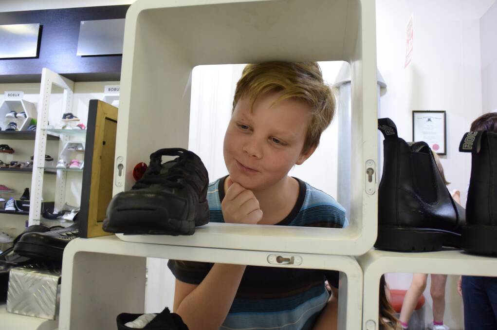 DECISIONS, DECISIONS: Tristan Tait, 10, of Wagga ponders his school footwear options at Evans Shoes. Pictures: Jody Lindbeck