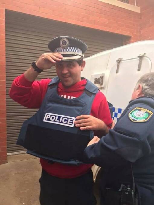 EAGER RECRUIT: Hamish Johnson spent a day at the Junee Police Station and was fitted with a hat and bullet-proof vest. 

