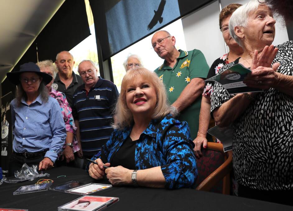 MEMORIES RELIVED: Little Pattie signs autographs and shares stories with a mass of adoring fans, including many Vietnam veterans and their wives. Picture: Les Smith 