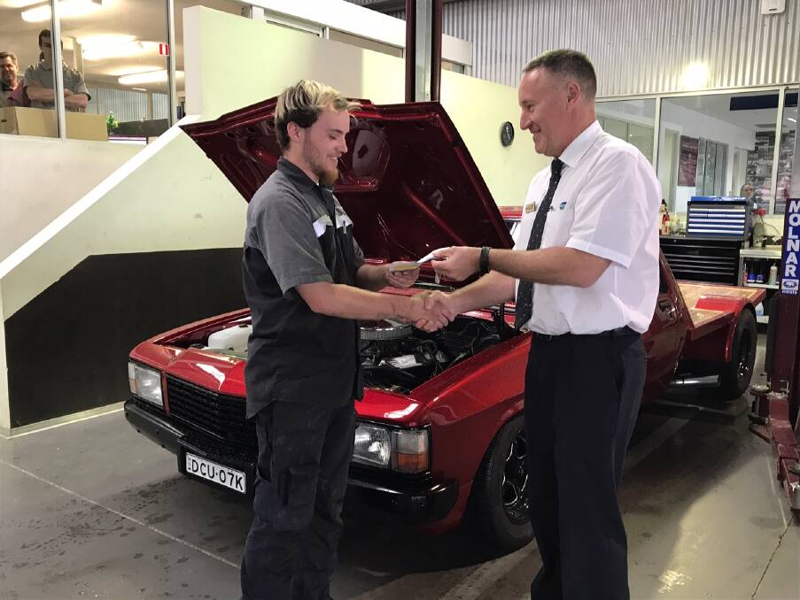 LUCK OF THE DRAW: GEO general manager Scott Brideoake hands over the keys to Brock Phillips. Picture: Supplied 
