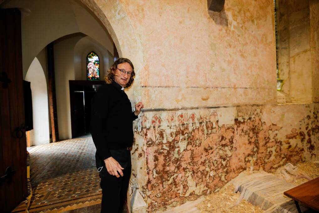 Discovery: Father Scott Lowrey with a decorative frieze found on the walls of Warrnambool's Christ Church which has been uncovered under seven layers of paint. This section will be restored. Picture: Anthony Brady.