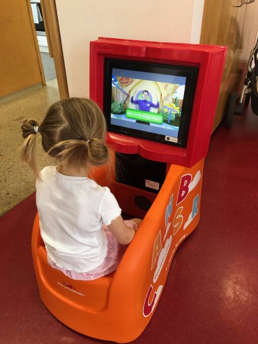 ENGROSSED: A young Junee resident enjoys the new Storypod in the Junee Library. Picture: Contributed.