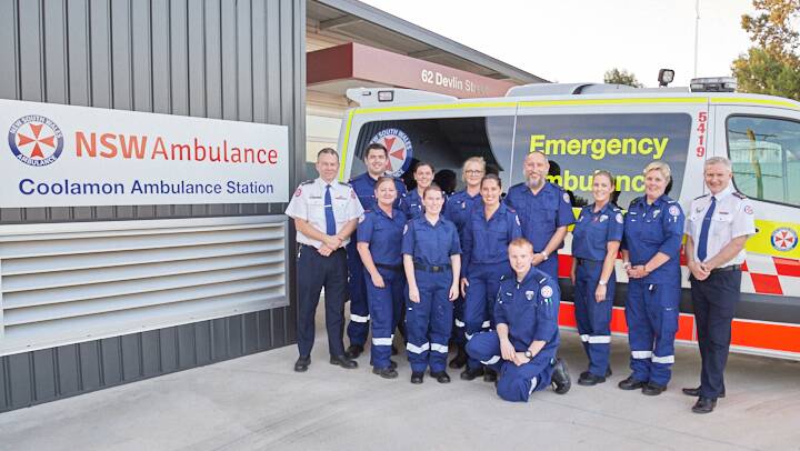 Team effort: Coolamon's paramedics and qualified volunteer ambulance officers with NSW Ambulance commissioner Dominic Morgan (left) and senior assistant-commissioner David Dutton (right).