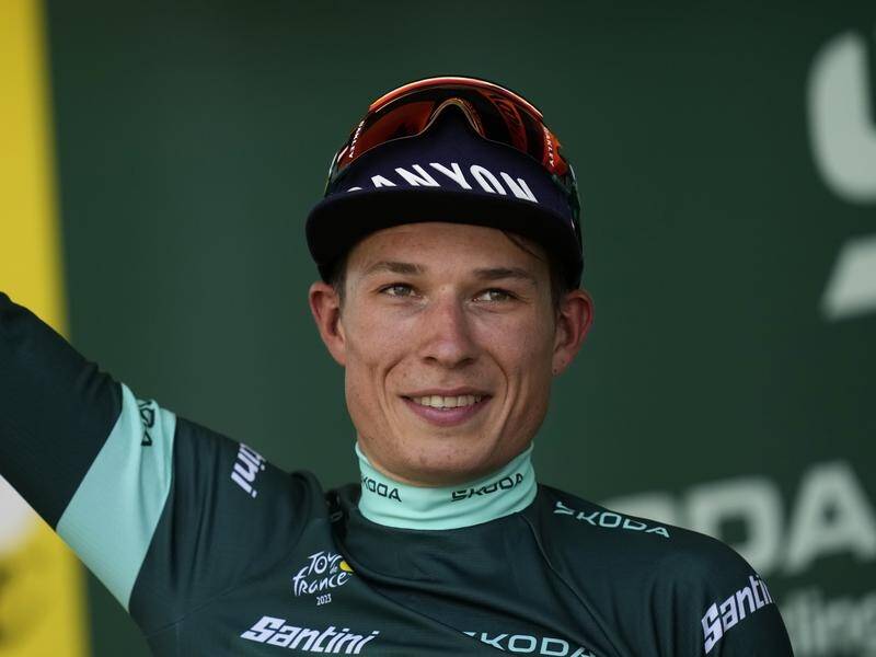 Belgium's Jasper Philipsen celebrates on the podium after his third stage win at the Tour de France. (AP PHOTO)