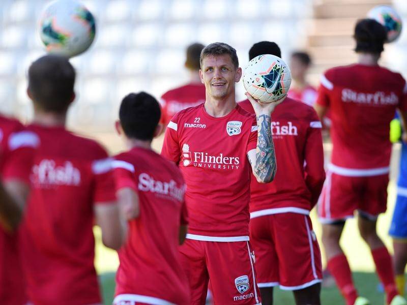 Adelaide United captain Michael Jakobsen (facing camera) has faith in the Reds' squad.
